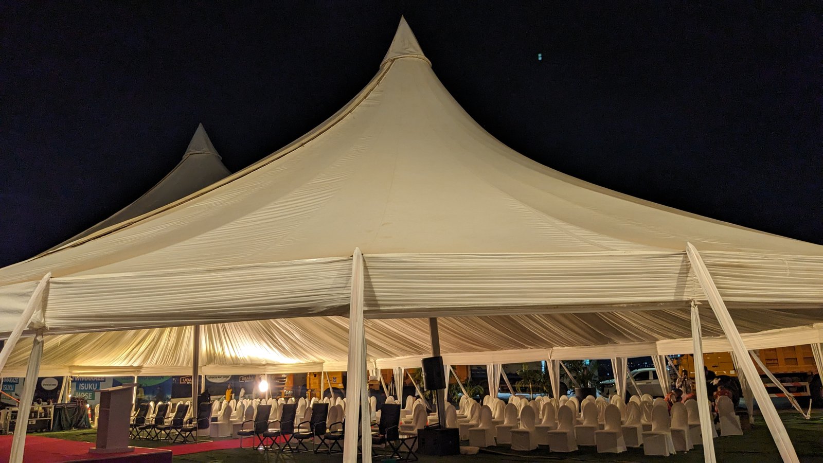 Front view of marquee tent with interior draping at night event
